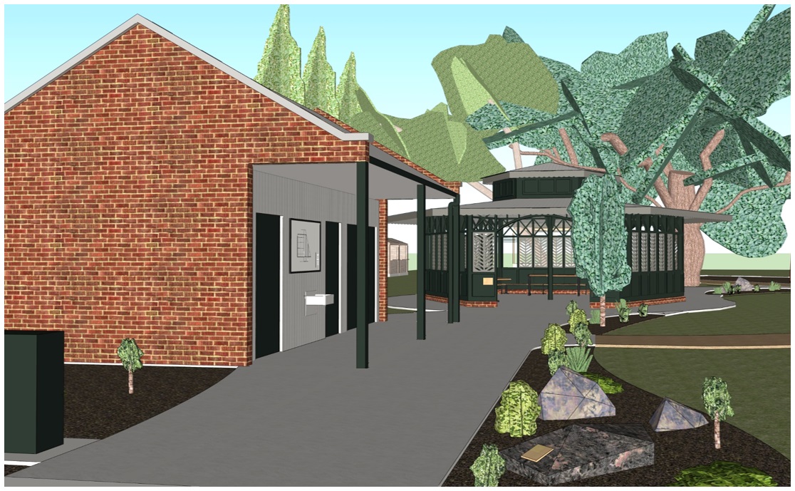 Park entry, 2m wide concrete path leading past a red brick toilet on left side, path continues to large rotunda with tables and BBQ's. High contrast entry points and accessible features.