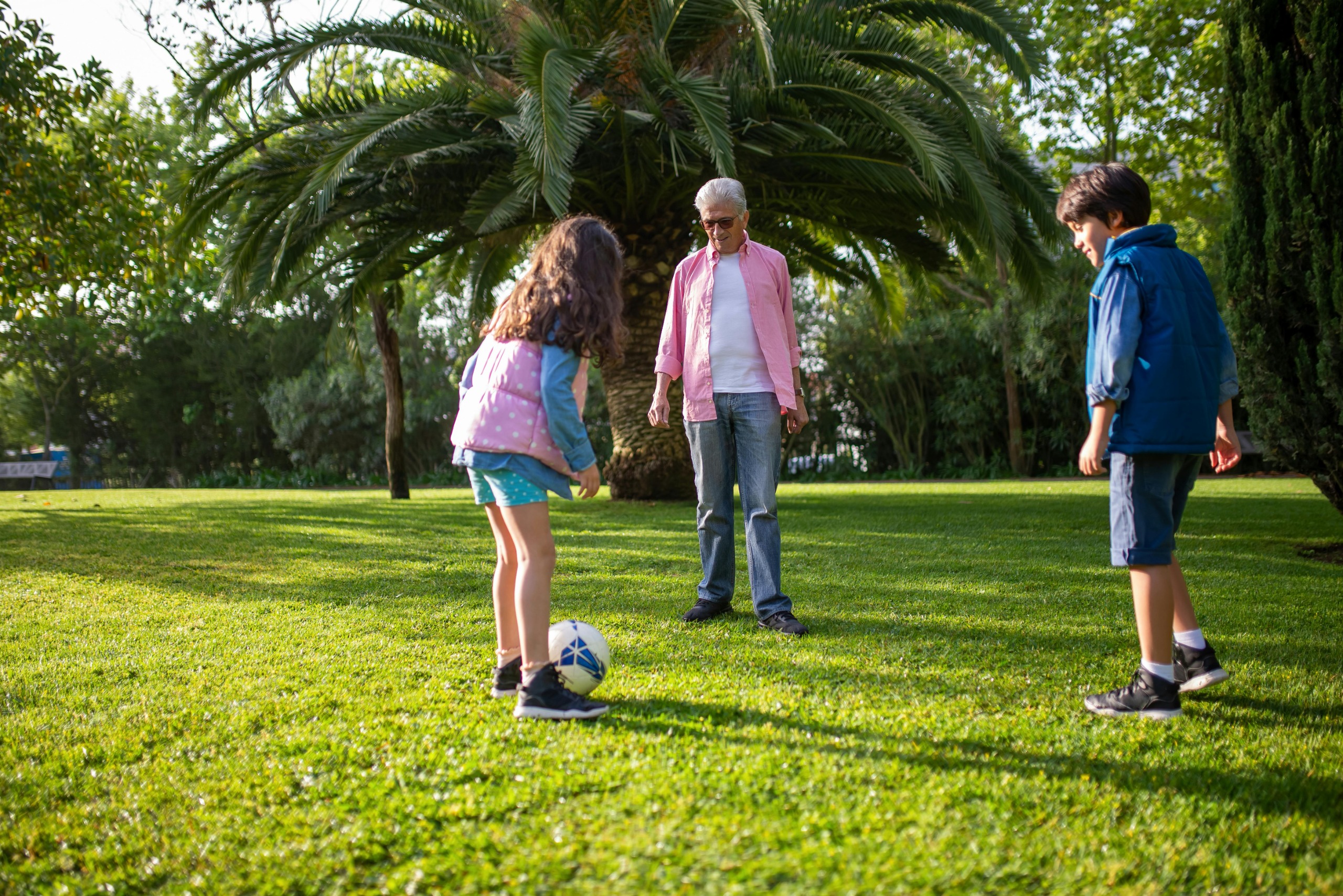 Active Recreation - Community members kicking soccer ball around in park