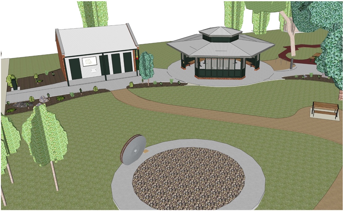 From above, concrete paths connect an open lawn to the toilet and rotunda. the rotunda sits to the right, the toilet building sits to the left. A main path loops between them, guiding movement past garden beds and seating areas, with clear routes leading into and around each structure.