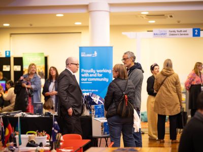 Community members exploring stalls and speaking with City of Ballarat staff during the Let’s Chat Ballarat 2026 Community Expo at Ballarat Civic Hall.